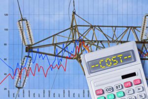 Increasing alberta electricity costs concept with power tower, transmission lines and calculator